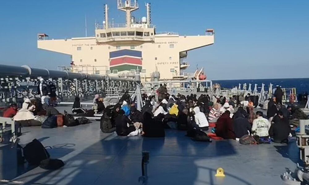 PICTURED: 150 freezing migrants shiver on the deck of a ship belonging to Nottingham Forest owner Evangelos Marinakis after they were plucked from the Mediterranean FOUR DAYS after their wooden boat began sinking